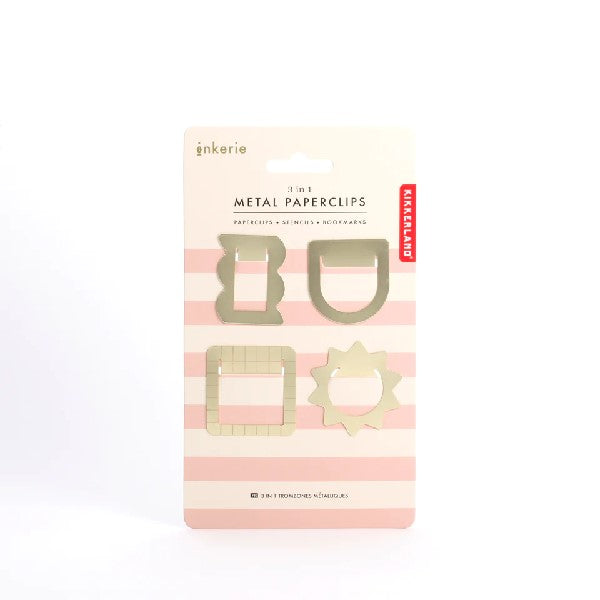 4 golden metal paperclip on a pink-stripped hanging package carton. shapes include sun-like, rounded square, rectangle with cloud-like bumps, and stretched half circle. kikkerland product on white background