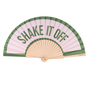 Open handheld fan with wooden ribs and the green text 'SHAKE IT OFF' printed on a light pink background with a green border. 