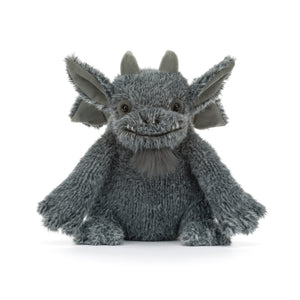 A gray plush gargoyle toy with large pointed ears, fangs, small horns, and a stitched smiling face with a gray beard. The plush is shown against a white background.