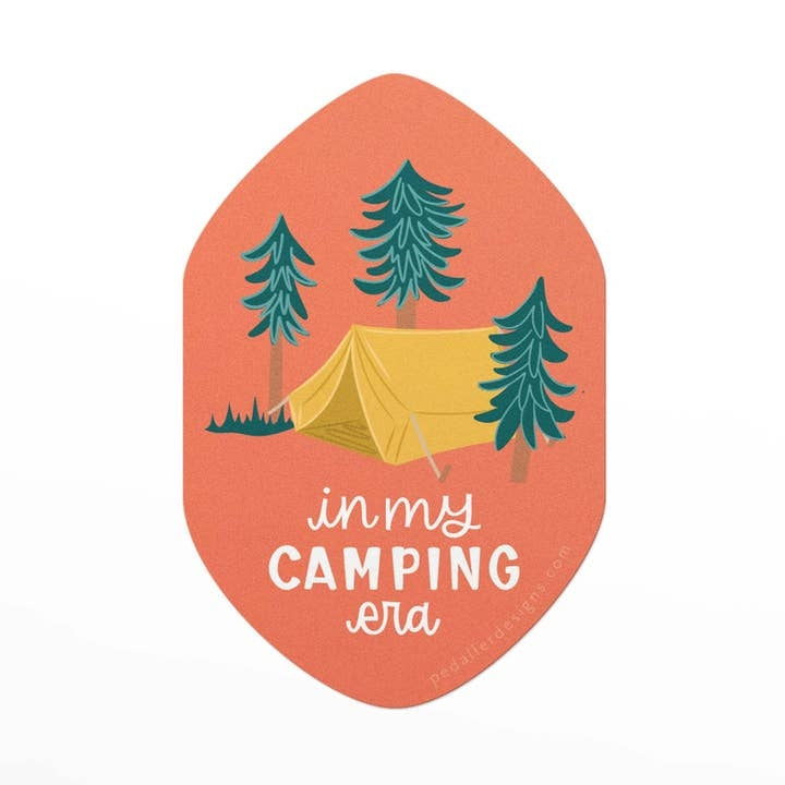 Sticker featuring an illustration of a tent and some trees on an orange background. The text 'in my camping era is printed under the tent.