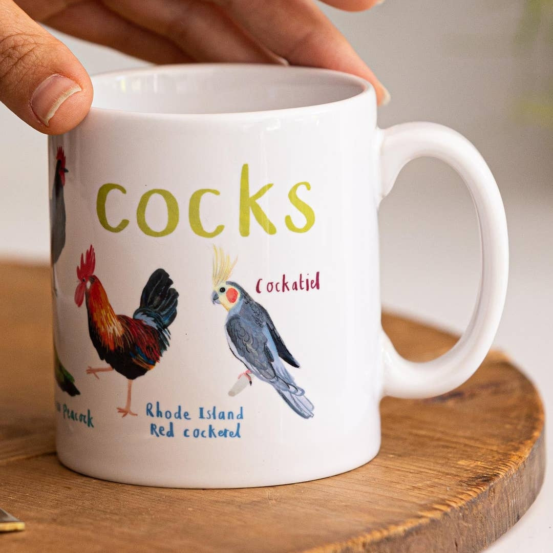 White mug with colourful bird themed illustrations. The text 'Cocks' is printed over the birds while different bird names are printed beside each illustration. 