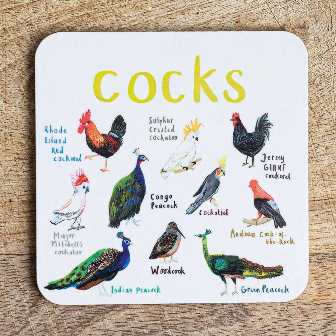 Coaster featuring illustrations of birds on a white background. Each bird is labelled, while the text 'Cocks' is printed on the top. The coaster sits on a wooden surface.