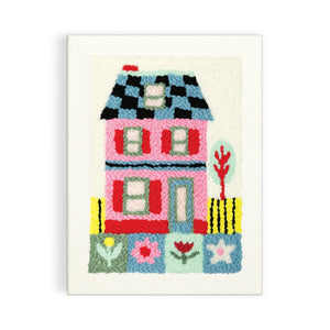 Finished punch needle design of a colourful house and garden. 
