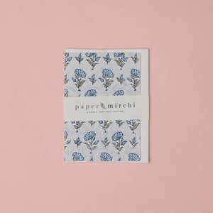 Cotton paper greeting card with a blue, green and gold botanical design on a pink background.