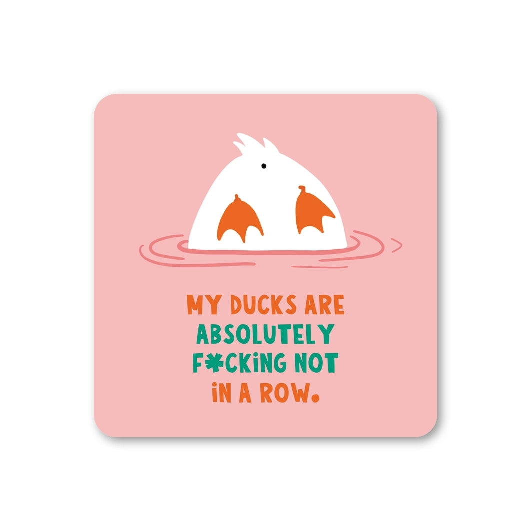 Coaster featuring a duck's butt sticking out of the water with the text 'My ducks are absolutely f*cking not in a row', on a pink background. 