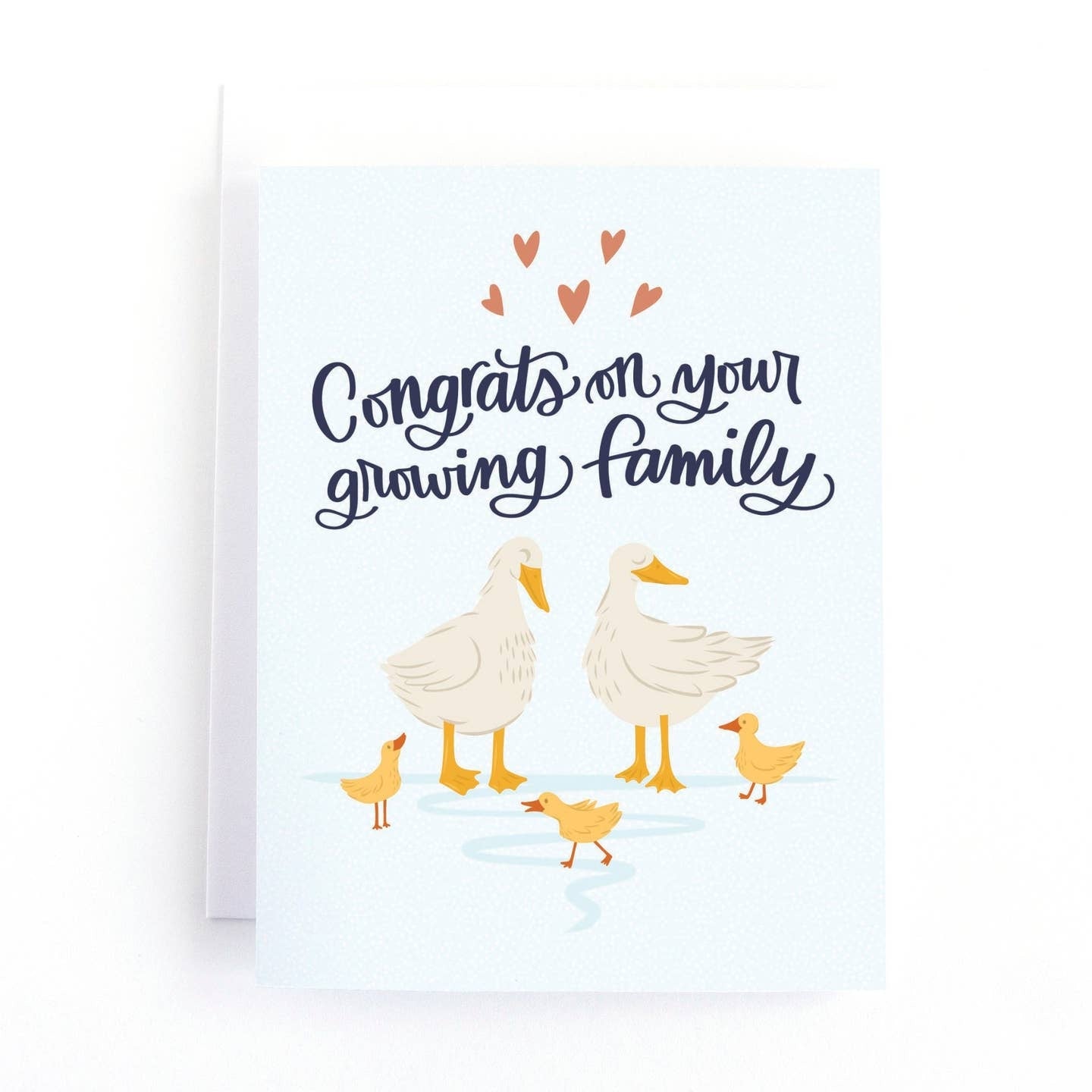 Greeting card with an illustration of two adult and three baby ducks on a white background. The text 'Congrats on your growing family' is printed across the top, along with some hearts. 