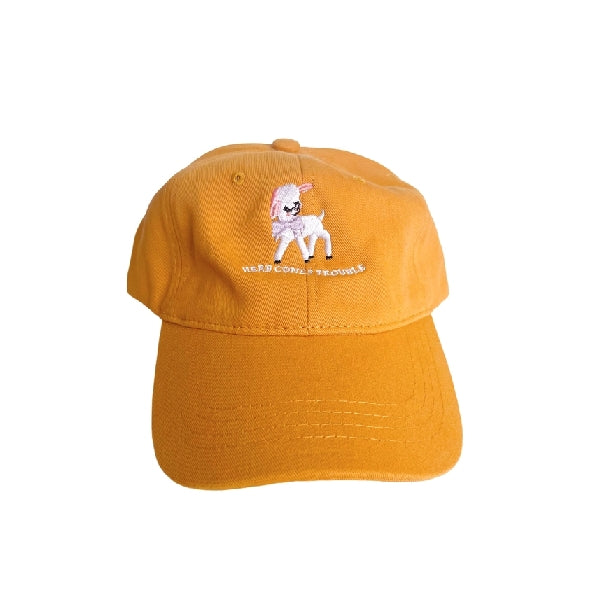 yellow dad hat with an embroidered design. a cute, lilac-wearing baby sheep stands above a text that reads "here comes trouble"