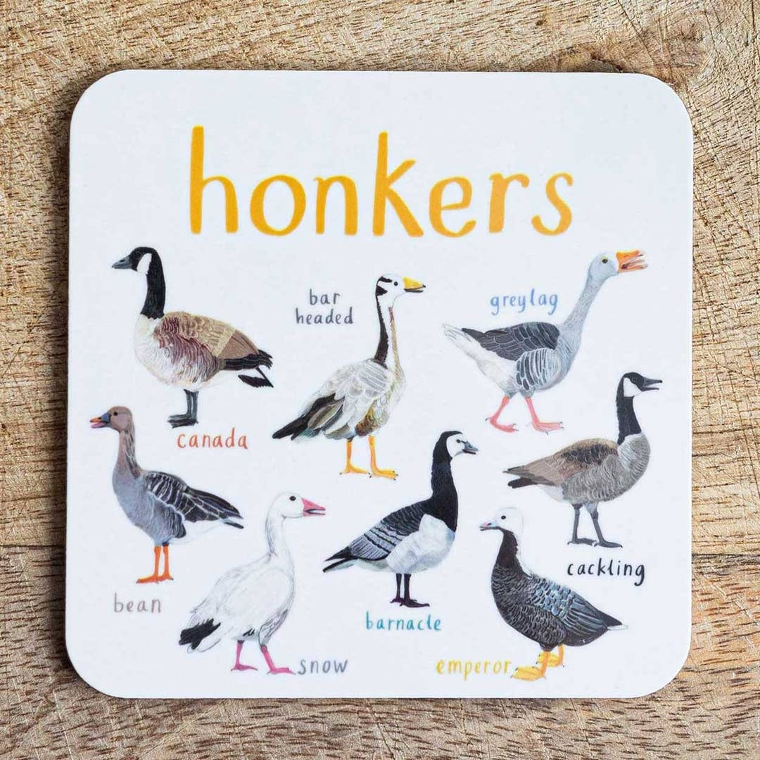 Coaster featuring illustrations of geese on a white background. Each goose is labelled, while the text 'Honkers' is printed on the top. The coaster sits on a wooden surface.