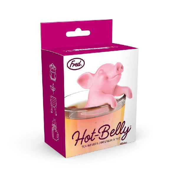 tea infuser in the shape of a pink smiling pig propping its head above a clear cup
