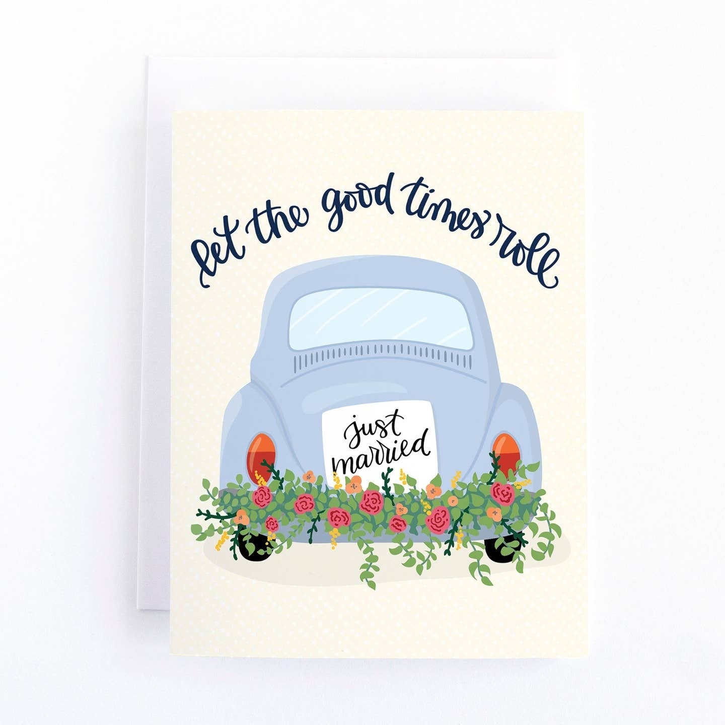 Greeting card featuring an illustration of the back view of a car with a sign saying 'Just Married' on the back, along with some flowers. The text 'Let the good times roll' is printed on a white coloured background. 