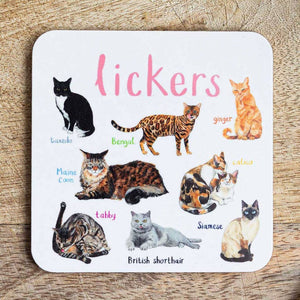 Coaster featuring illustrations of cats on a white background. Each cat is labelled, while the text 'Lickers' is printed on the top. The coaster sits on a wooden surface.