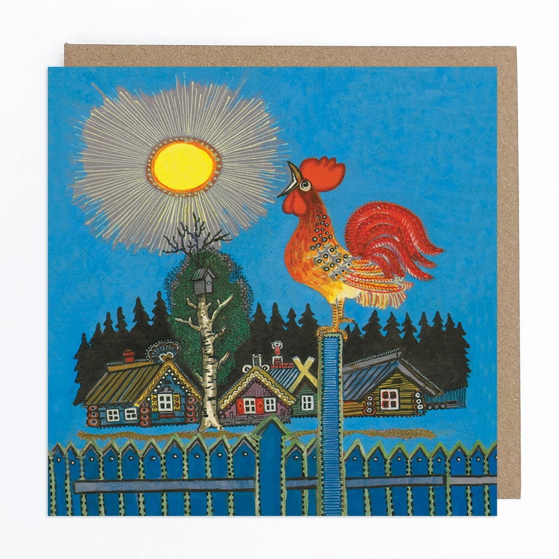 Card featuring a folk art style illustration of a rooster perched on a blue fence with it's beak open. In the background there are four colourful wooden houses and some trees against a blue background. There is a rising sun above the houses. 