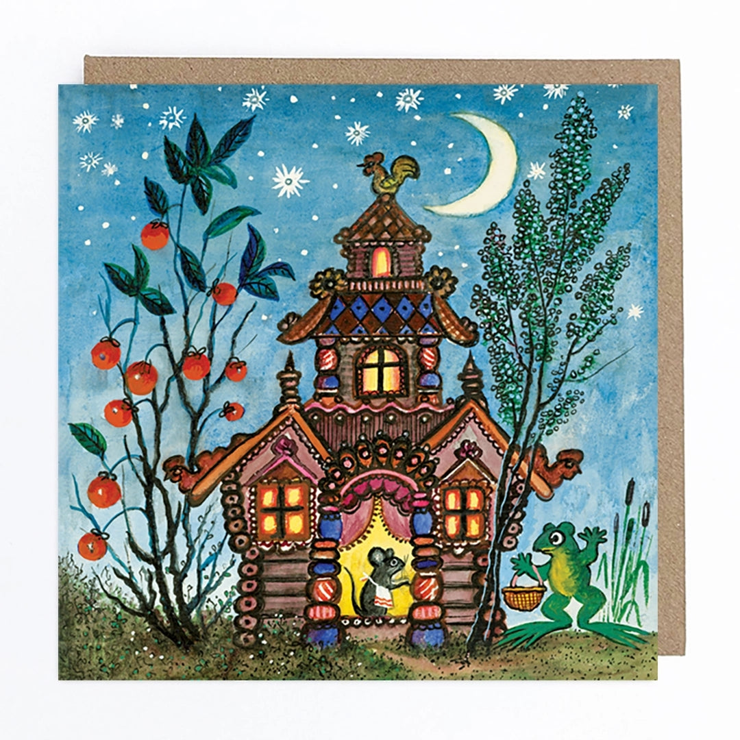 Card featuring a folk art style illustration of a colourful three story house. The house is set against a blue sky with a moon and stars, and beside a tall plant growing what appears to be tomatoes. Inside the door of the house, a mouse stands wearing an apron, while a frog holding a basket stands beside the house. 