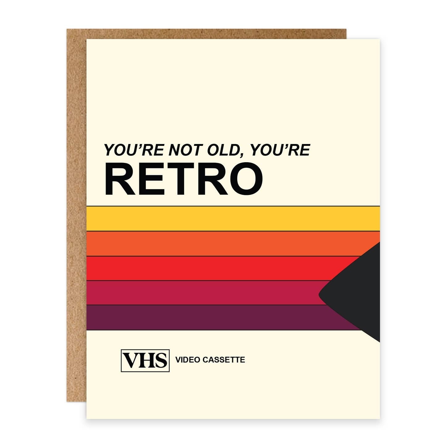 Greeting card featuring a colourful print inspired by a VHS video cassette tape. The text 'You're not old, you're retro' is printed on the card. 