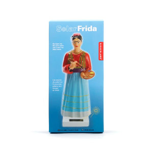 blue gradient box on white background. box has text and an image of the product inside; a Frida Kahlo holding a paintbrush and a palette statuette on a tiny white solar captor. kikkerland product