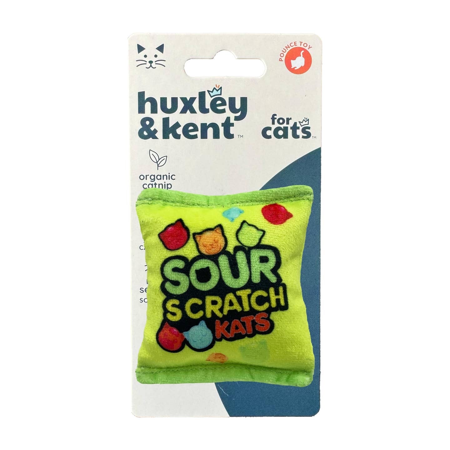 A green novelty cat toy designed to look like a pack of Sour Patch Kids. The logo for 'Sour Scratch Kats' is printed on the centre of the toy while illustrations of red, orange, blue and green cat-shaped candy is scattered around the logo.
