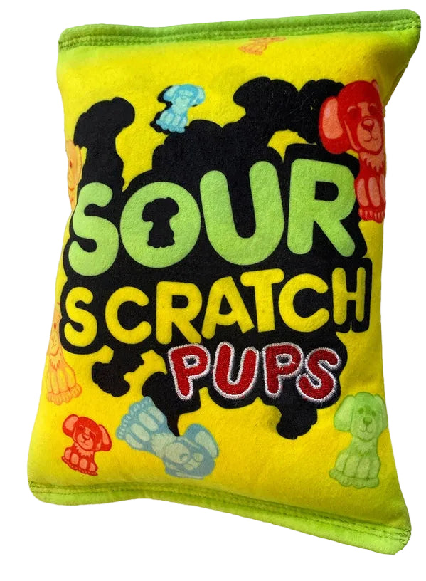 A yellow and green novelty toy designed to look like a Sour Patch Kids snack bag, shown from both sides. The logo for 'Sour Scratch Pups' is printed on the centre of the toy, while colourful illustrations of dog shaped candy surround the logo.