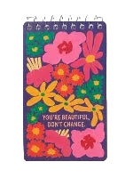 A spiral-bound notebook with a colorful floral cover design and the text 'You're Beautiful, Don't Change'.