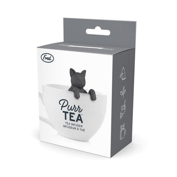 tea infuser in the shape of a black cat propping its head above a white tea cup