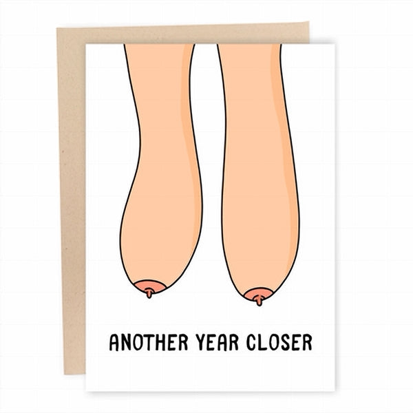 white birthday card with hanging beige breasts. bottom text reads "another year closer"