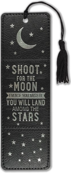 black leather bookmark with a black tassle and silver details of stars and a moon. middle text reads "shoot for the moon even if you miss it you will land among the stars" in silver
