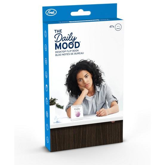 Box containing the "daily mood tracker", a desk accessory in the shape of a notebook with various emotions illustrated in it.